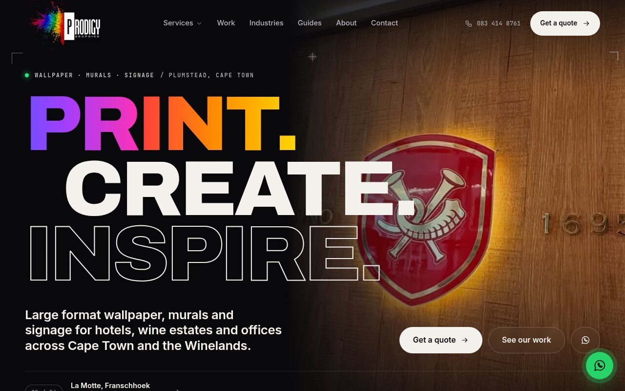 Prodigy Graphics homepage hero reading Print. Create. Inspire. over a halo-lit crest on an oak wall